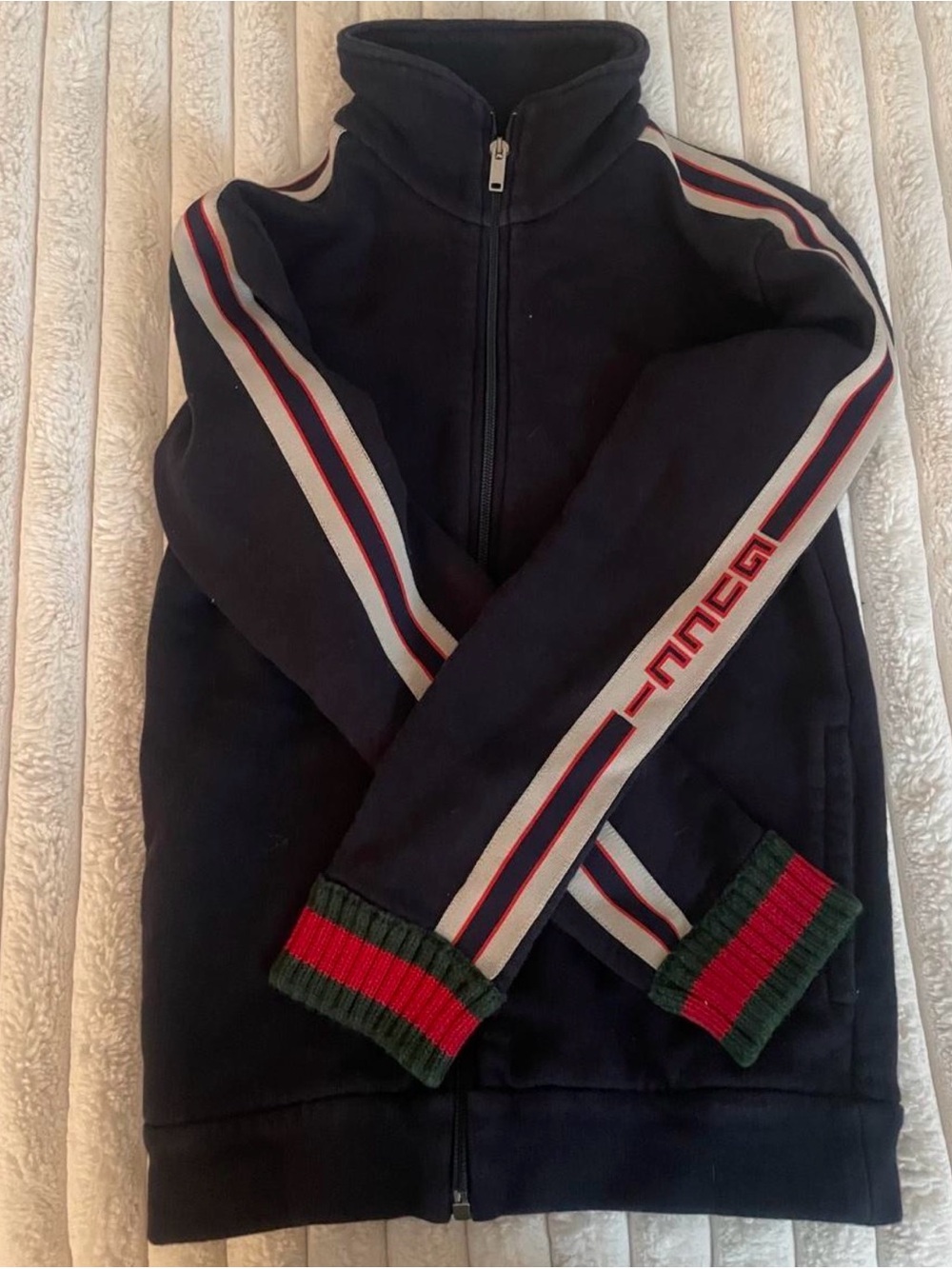 Gucci Black Garment Tag on Navy Background